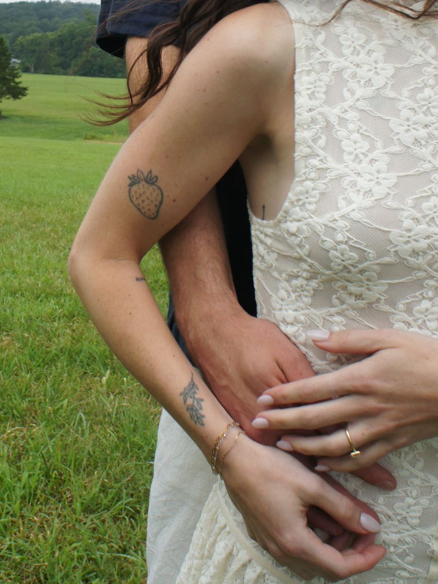 A close-up of Melanie's lace dress and their hands
